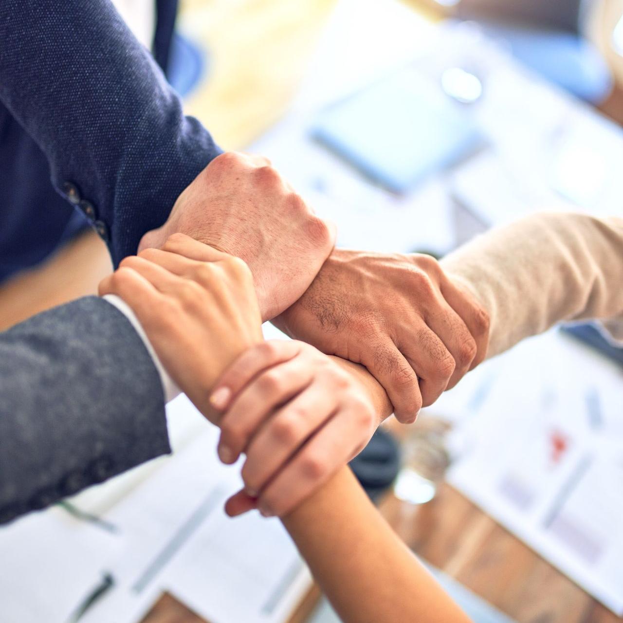 person in black long sleeve shirt holding persons hand